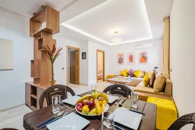 a dining room with a table with a bowl of fruit at 3 min de Guéliz - Appart avec balcon , vue piscine in Marrakech