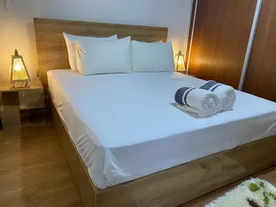 a bed with white sheets and towels on it at Luxury Apartment Near Airport & Medina in Marrakech