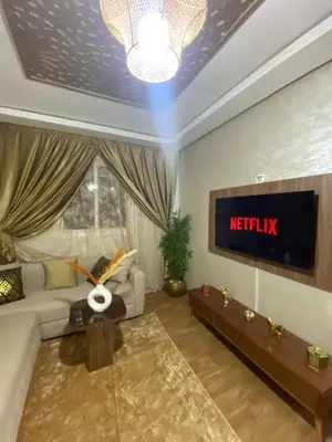 a living room with a couch and a tv at Luxury Apartment Near Airport & Medina in Marrakech