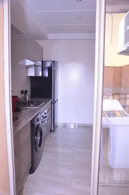 a kitchen with a washer and dryer in it at Appartement moderne in Marrakech