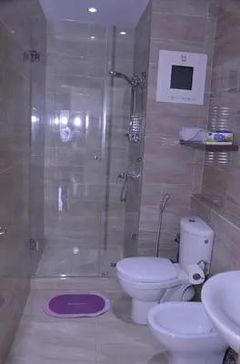 a bathroom with a shower and a toilet and a sink at Appartement moderne in Marrakech