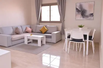 a living room with a couch and a table at Appartement moderne in Marrakech