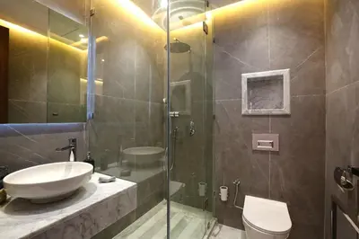 a bathroom with a toilet and a sink and a shower at Heart of City 2BR 2Patios Fiber AC Modern New Calm in Marrakech