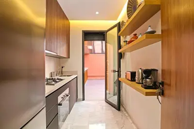 a small kitchen with a sink and a stove at Heart of City 2BR 2Patios Fiber AC Modern New Calm in Marrakech