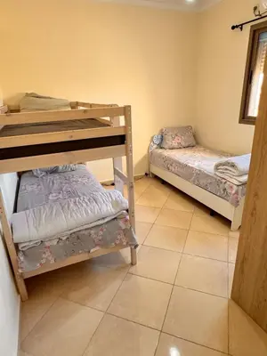 a room with two bunk beds and a tiled floor at Appartement sur Marrakech in Marrakech