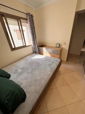 a bedroom with a large bed and a window at Appartement sur Marrakech in Marrakech