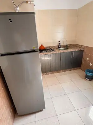 a stainless steel refrigerator in a kitchen with a sink at Appartement sur Marrakech in Marrakech
