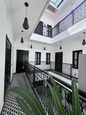 a balcony of a house with black and white at Riad Looma in Marrakech