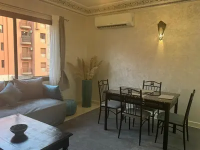 a living room with a table and chairs and a couch at Elegant Apartment in Marrakech Gueliz in Marrakech