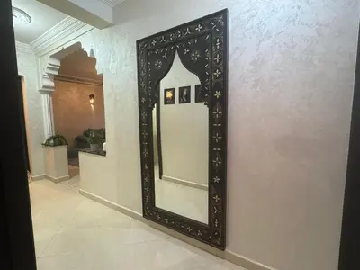 a large mirror on a wall in a hallway at Elegant Apartment in Marrakech Gueliz in Marrakech