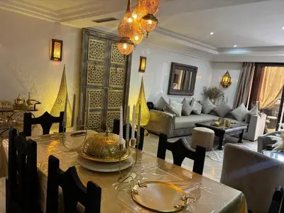 a dining room with a table and a living room at Central Fiber Optic Pool in Marrakech