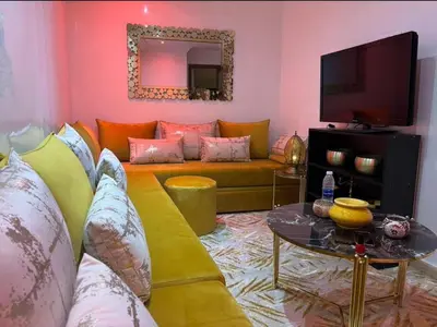 a living room with a couch and a tv at Central Fiber Optic Pool in Marrakech