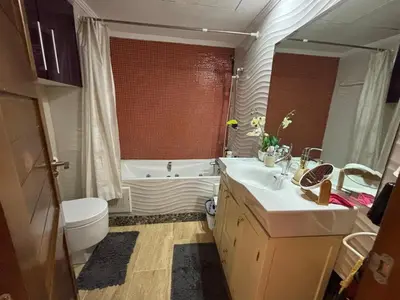 a bathroom with a tub and a sink and a toilet at Central Fiber Optic Pool in Marrakech