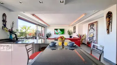 a kitchen and living room with a table and chairs at Exceptional View & Hot Tub Marrakesh in Marrakech