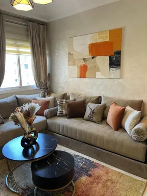a living room with a couch and a table at Dar Mezhor apartment in Marrakech