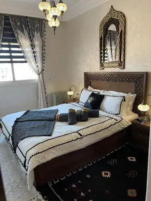 a bedroom with a large bed with a large mirror at Dar Mezhor apartment in Marrakech