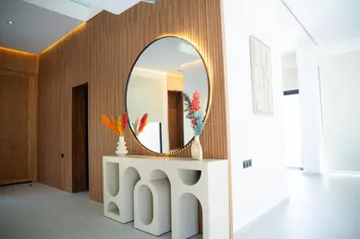 a mirror on a wall in a room with a table at Modern Villa Selma in Marrakech