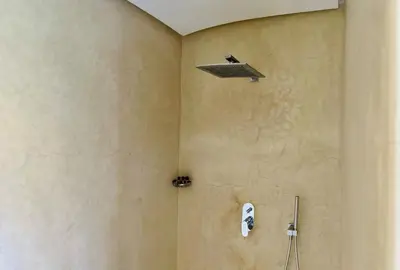 a shower with a shower head in a bathroom at Spacious Villa with Mountain Views - 550 m² in Marrakech