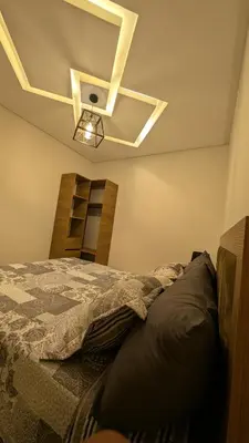 a bedroom with a bed and a light on the ceiling at Stylish Apart Near City Center in Marrakech