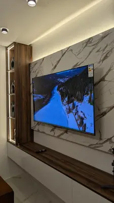 a flat screen tv on a wall in a room at Stylish Apart Near City Center in Marrakech