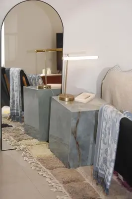 a living room with a table and a mirror at Charming duplex appartment in Marrakech