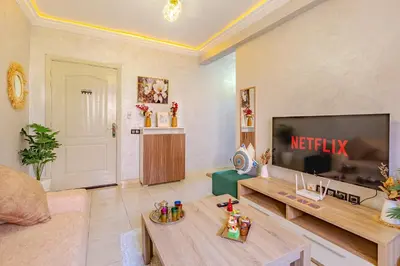 a living room with a large flat screen tv at Oasis de charme au cœur de Marrakech in Marrakech