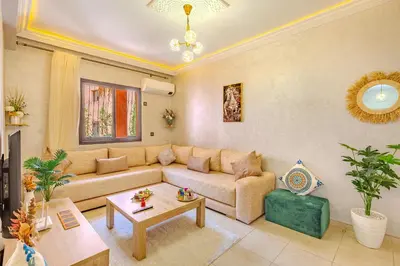 a living room with a couch and a table at Oasis de charme au cœur de Marrakech in Marrakech