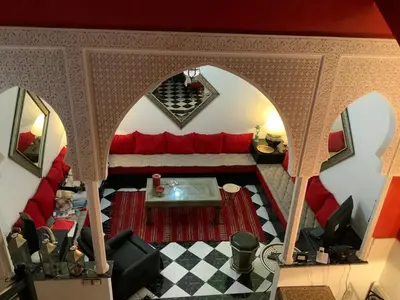 an overhead view of a living room with a red couch at Comfortable house with pool in Marrakech