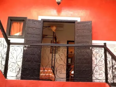 a balcony with an open door in a building at Comfortable house with pool in Marrakech