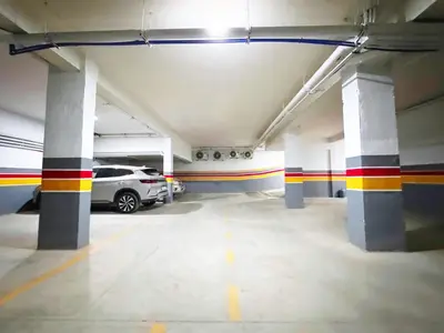 a parking garage with a car parked in it at Modernes Apartment in Top-Lage in Guéliz Marrakech in Marrakech