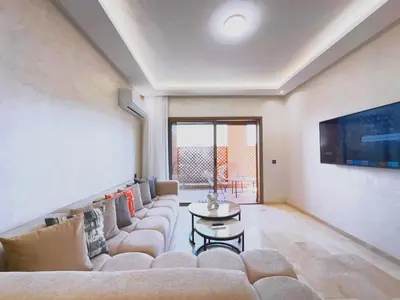 a living room with a couch and a table at Modernes Apartment in Top-Lage in Guéliz Marrakech in Marrakech