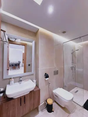 a bathroom with a sink and a shower and a toilet at Modernes Apartment in Top-Lage in Guéliz Marrakech in Marrakech