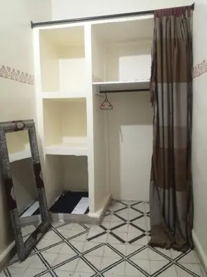 a small room with a mirror and a shelf at Apartment 3 mins Place jamaa el fana in Marrakech