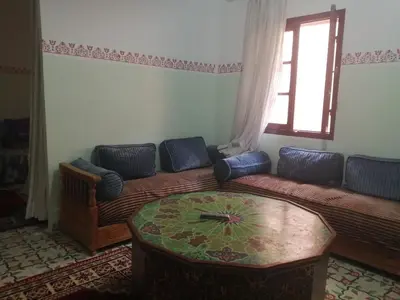 a living room with a couch and a table at Apartment 3 mins Place jamaa el fana in Marrakech