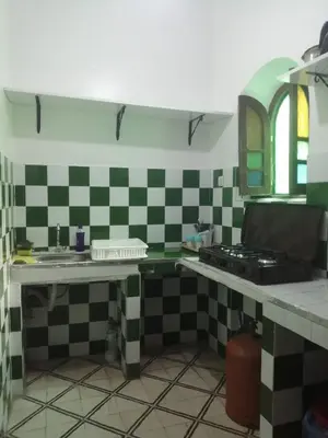 a kitchen with black and white checkered tiles at Apartment 3 mins Place jamaa el fana in Marrakech