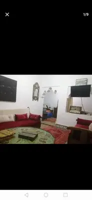 a room with a bed with red pillows at Grand appartement à 3 minutes de la place jamaa el fana in Marrakech