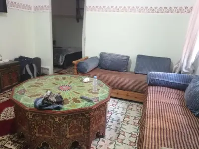 a living room with a couch and a table at Grand appartement à 3 minutes de la place jamaa el fana in Marrakech