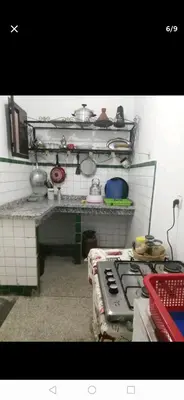 a kitchen with a stove and some pots and pans at Grand appartement à 3 minutes de la place jamaa el fana in Marrakech