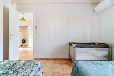 a bedroom with two beds and a hallway at Design Elegant Appartement in Marrakech