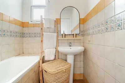 a bathroom with a sink and a bath tub and a sink at Design Elegant Appartement in Marrakech