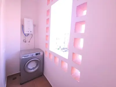 a washing machine in a bathroom with a window at Design Elegant Appartement in Marrakech