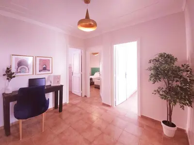 a living room with a desk and a bedroom at Design Elegant Appartement in Marrakech