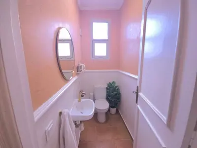 a bathroom with a toilet and a sink and a mirror at Design Elegant Appartement in Marrakech
