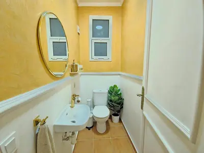 a bathroom with a toilet and a sink and a mirror at Design Elegant Appartement in Marrakech