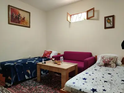 a room with a bed and a table and a couch at غرفة مريحة و نضيفة in Marrakech