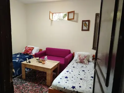 a living room with a purple couch and a table at غرفة مريحة و نضيفة in Marrakech