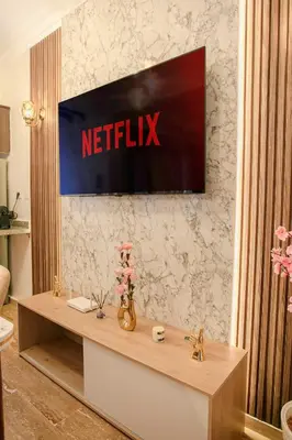 a television on a wall with a netflix sign on it at Traditionnel Boutique - Marrakech Downtown in Marrakech