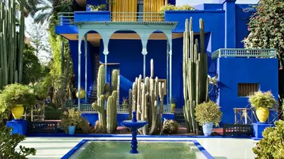 a blue building with a fountain and cactus at Traditionnel Boutique - Marrakech Downtown in Marrakech