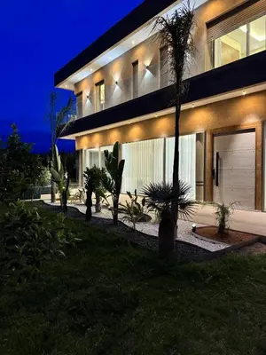 a house with lights on the side of it at Villa Maymouna in Marrakech