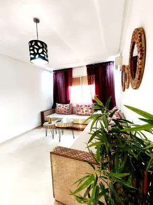 a living room with a couch and a table at Appartement cosy Marrakech in Marrakech
